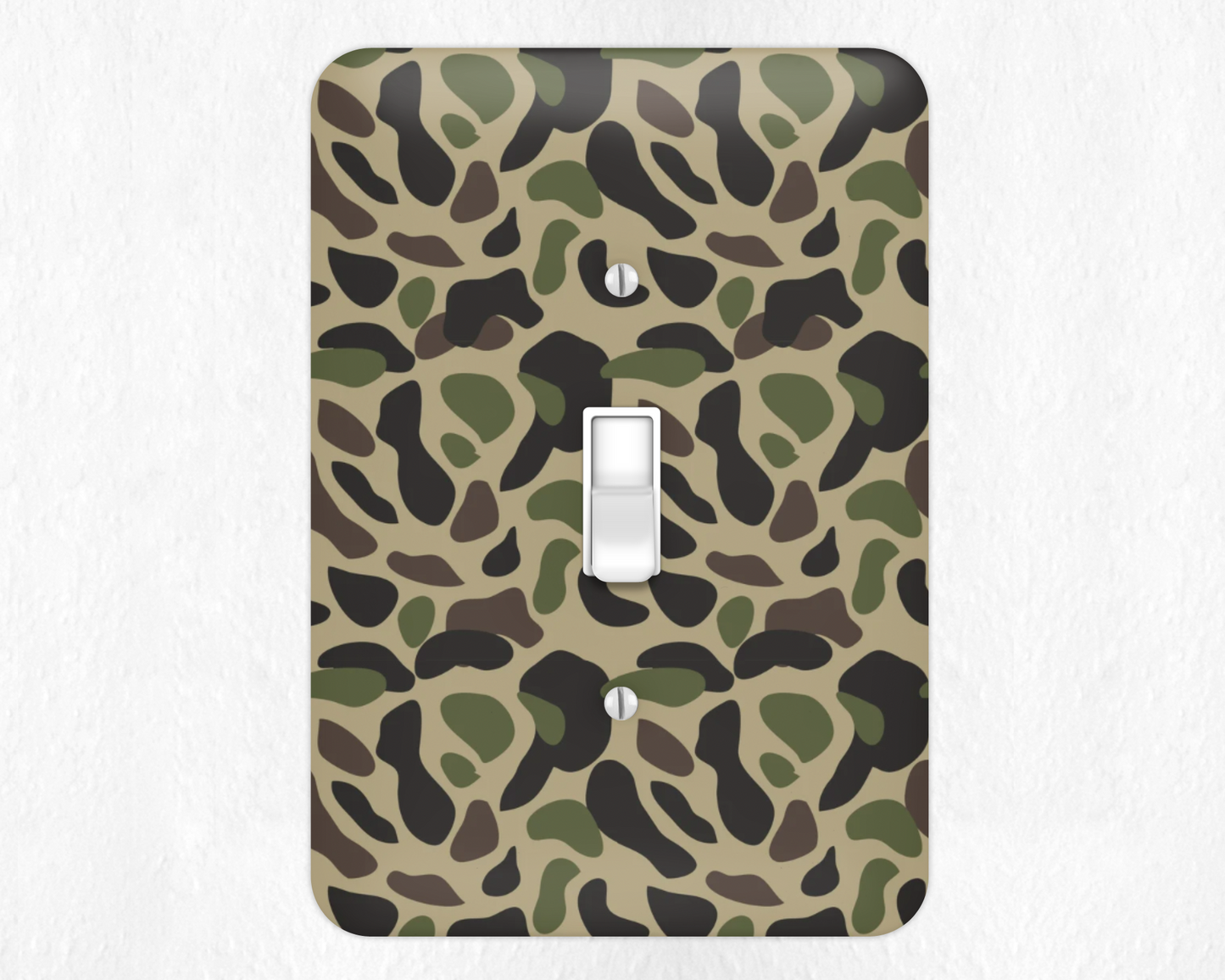 Camouflage-patterned light switch cover on a white background