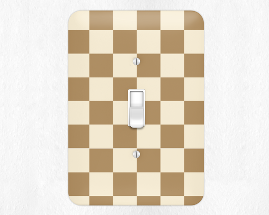 Checkered light switch cover with a beige and brown pattern on a white background
