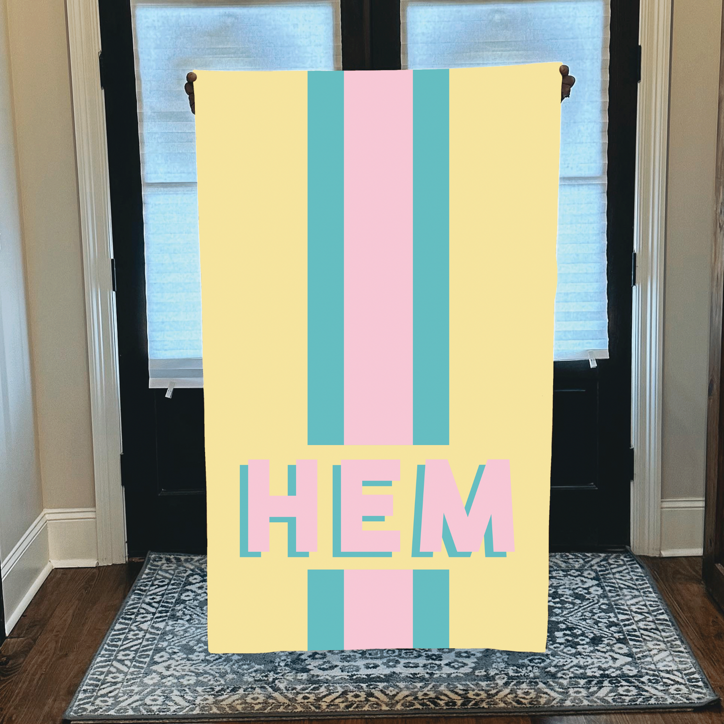 Personalized beach towel with custom monogram and striped pastel design