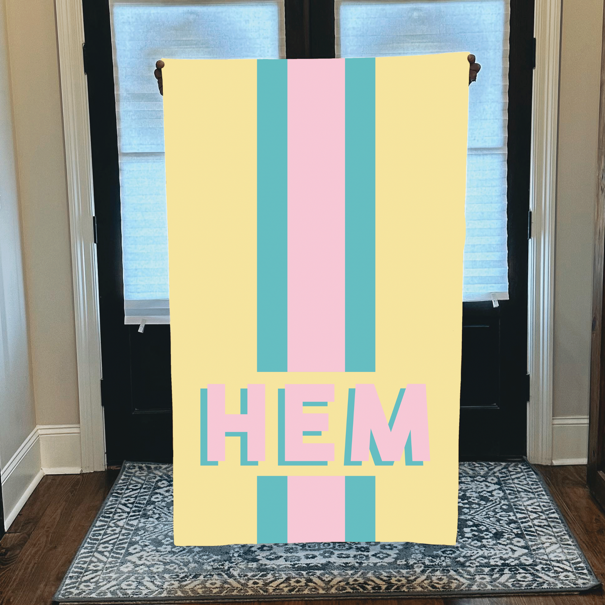 Personalized beach towel with custom monogram and striped pastel design