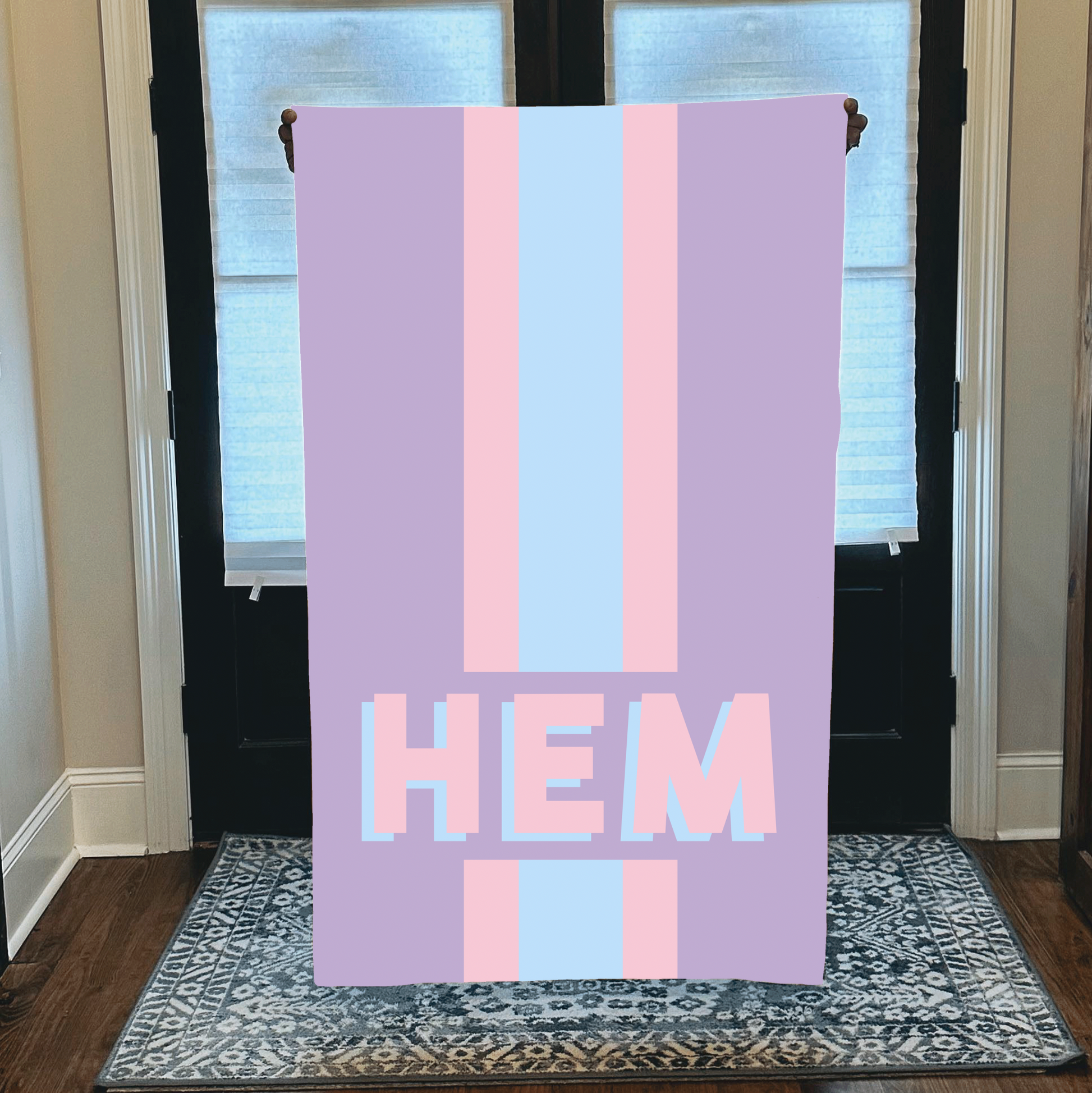 Personalized beach towel with custom monogram and striped pastel design